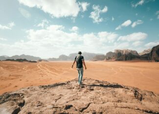 traveler exploring rocky arid terrain during vacation
