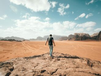 traveler exploring rocky arid terrain during vacation